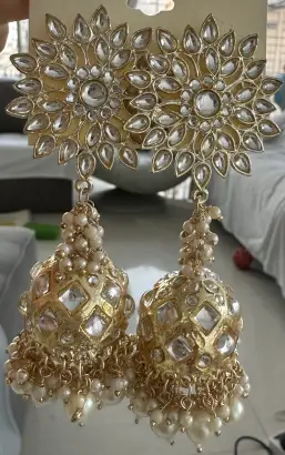 Traditional pearl jhumka earrings.
