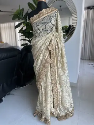 Cream chantilly lace saree with intricate gold border