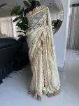 Cream chantilly lace saree with intricate gold border