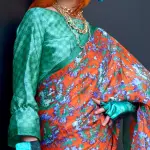 Orange & green contemporary printed satin crepe saree
