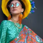Orange & green contemporary printed satin crepe saree